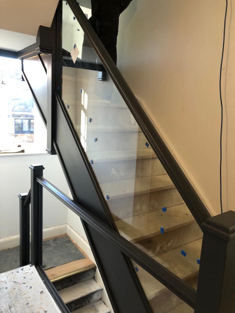 Glazed balustrade being installed as part of the extension